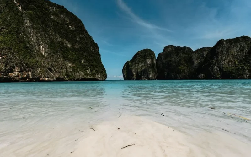 Breathtaking view of Maya Bay's turquoise waters and limestone cliffs in Krabi, Thailand.