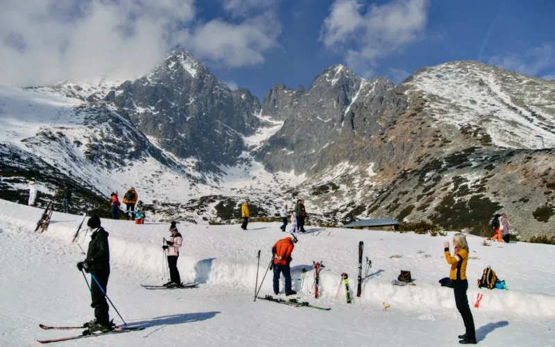 People skiing in the scenic High Tatras mountains of Slovakia, showcasing a winter wonderland.