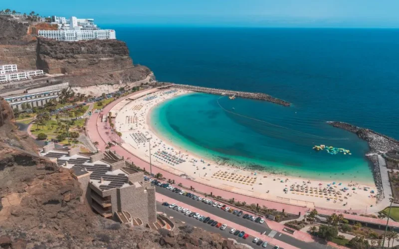 Stunning aerial view of Playa de Amadores beach with turquoise sea in Gran Canaria, Spain.