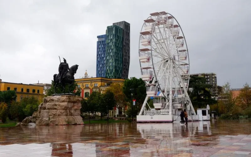 Explore the vibrant Skanderbeg Square in Tirana, featuring a ferris wheel and iconic statue.