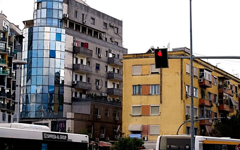 A vibrant cityscape of Tirana showcasing modern buildings and traffic activity.
