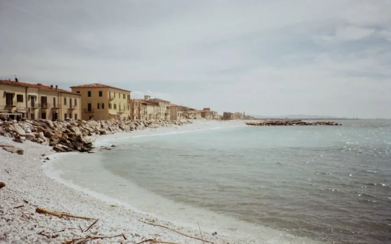 Tranquil beachfront in Piza, Tuscany captured on a serene day with clear skies.
