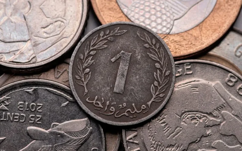 A diverse collection of Tunisian coins showcasing intricate designs and textures in close-up view.