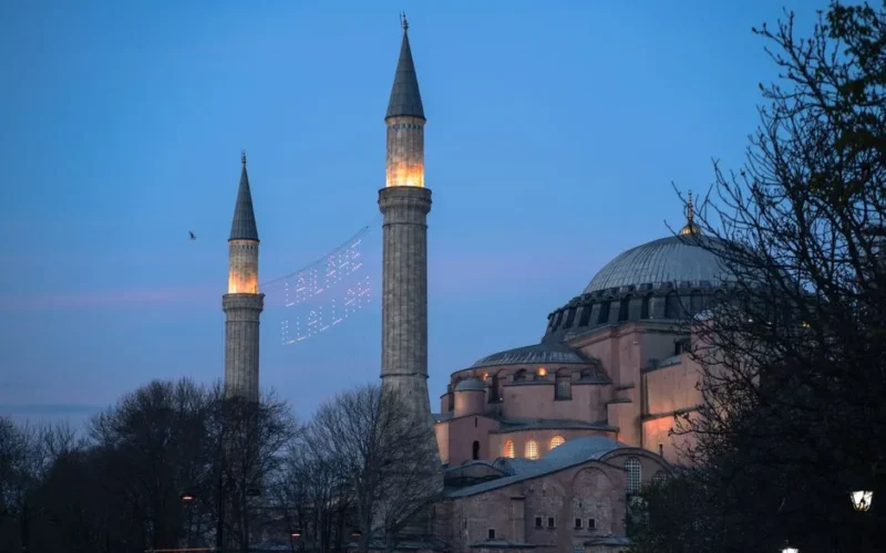 Hagia Sophia's minarets glowing at twilight, Istanbul landmark.