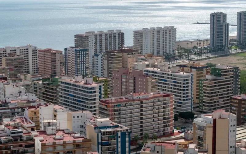 Stunning aerial view of Valencia's coastal cityscape with modern architecture and the shimmering sea.