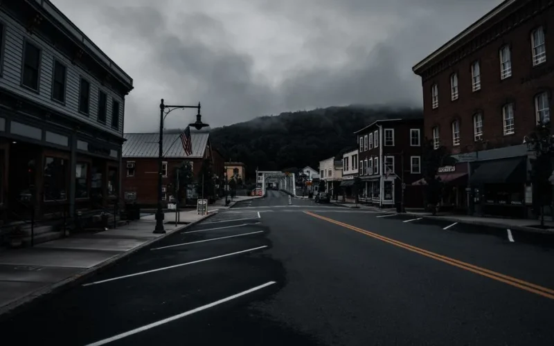 Empty town street with historic buildings and moody clouds. Perfect for travel or urban exploration themes.