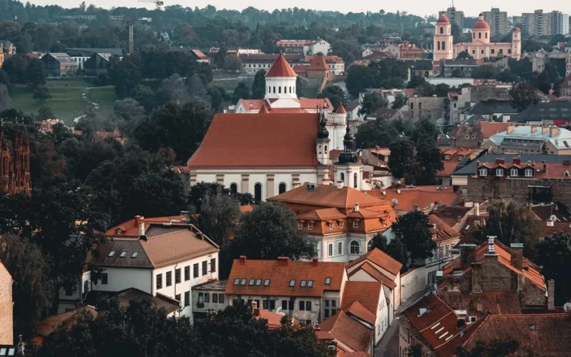 Charming aerial view of Vilnius old town with red-roofed buildings and historic architecture.