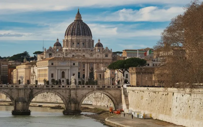 Scenic view of St. Peter's Basilica and bridge over the Tiber River in Rome.