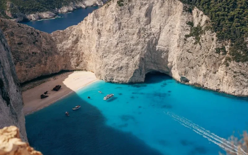Stunning aerial view of Navagio Beach with crystal clear waters and scenic cliffs in Zakynthos, Greece.