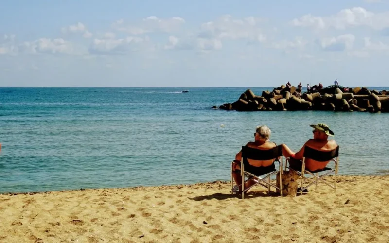 Senior couple enjoying a relaxing day on Varna beach with serene ocean views.