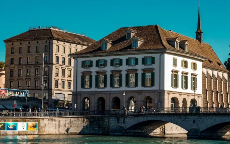 Scenic view of Zürich's historic waterfront and architectural charm on a sunny day.