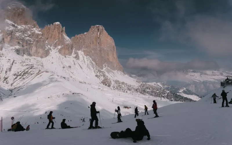 Skiers enjoy a snowy day at the Dolomites in Campitello di Fassa.