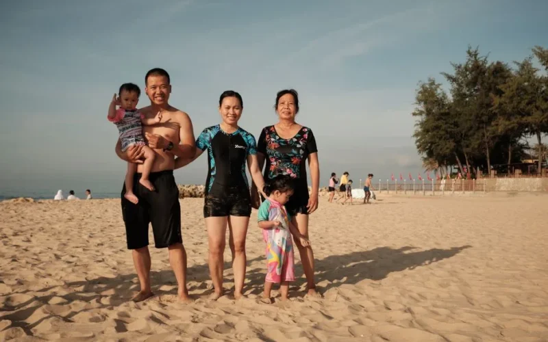 Family enjoying quality time on a sunny beach, creating lasting memories.